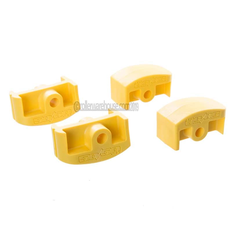 Four yellow plastic inline aggressive frame inserts against a white background.