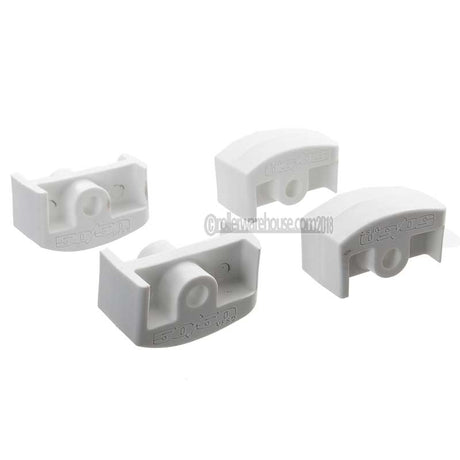 Four white plastic inline aggressive frame inserts on a white background
