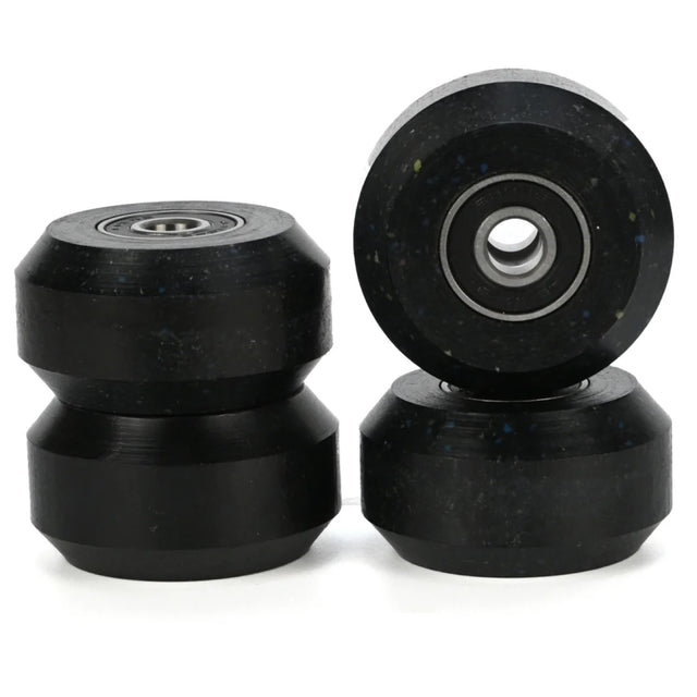 4 black aggressive inline skating anti rocker wheels with black bearings inside them. there are 2 stacked in the left of the image and 2 stacked on the right. the background is white.