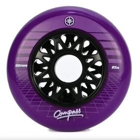 A single purple inline skate wheel with a black multi-spoke hub, featuring the brand name Compass and a "compass star" logo, on a white background.
