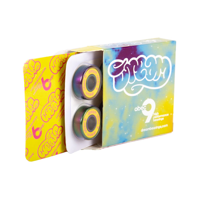 A brightly multi-colored, blue, purple and yellow open box with a company logo and descriptive product info that reads "dream abec 9 high performance bearings". The open box has 2 skate bearings in their packaging stick out.