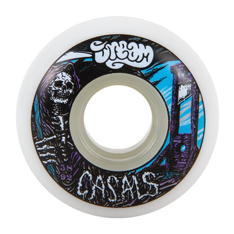 A single white urethane wheel with a black, purple, white and black graphic depicting a skeleton grim reaper and a gallows with company logo that reads "DREAM' and text that reads "CASALS" on a white background. 