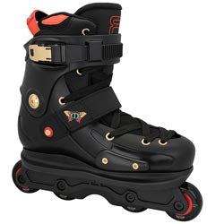 A black inline skate boot with gold hardware, red accents, and white wheels, shown against a plain white background.