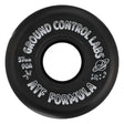 A close up shot of a black skate wheel with white text that reads "GROUND CONTROL LABS 57mm 90A ATF FORMULA" and a white graphic of a planet with a ring. The wheel is featured on a white background.
