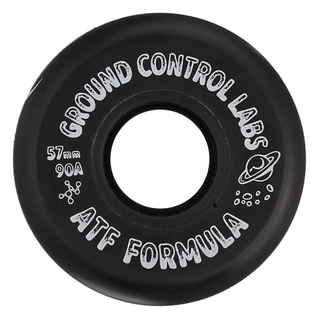 A close up shot of a black skate wheel with white text that reads "GROUND CONTROL LABS 57mm 90A ATF FORMULA" and a white graphic of a planet with a ring. The wheel is featured on a white background.