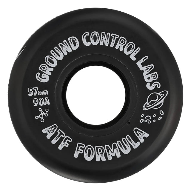 A close up shot of a black skate wheel with white text that reads "GROUND CONTROL LABS 57mm 90A ATF FORMULA" and a white graphic of a planet with a ring. The wheel is featured on a white background.