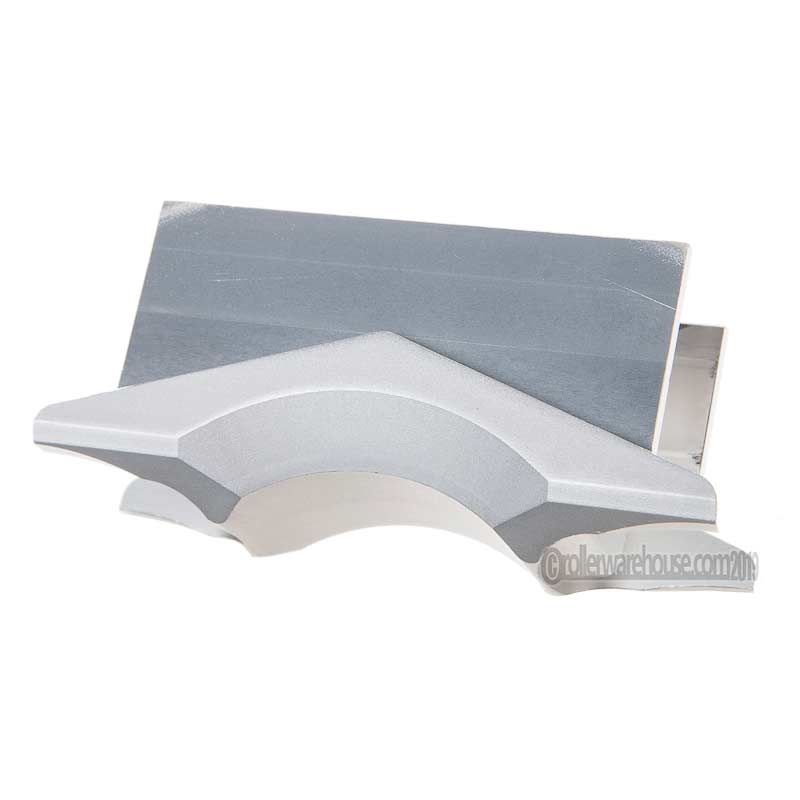 A close up image of a silver metal aggressive skate part called an H Block. The piece of metal has many corners and grooves that are specific to the part. It is featured against a white background.