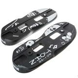 Two Black aggressive inline skate parts called soul plates with a white graphic and screw holes milled into them. they are featured on a white background.