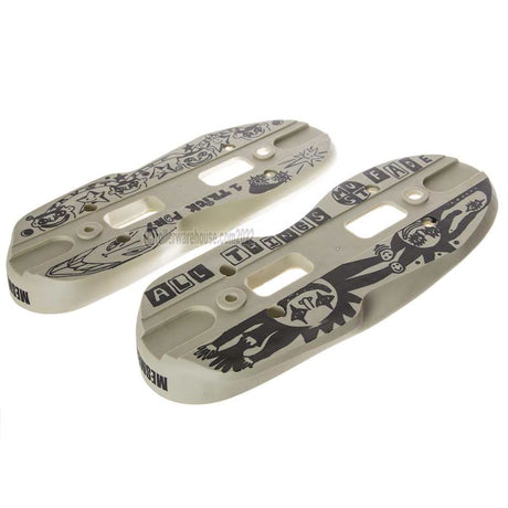 Two cream or sand colored aggressive inline skate parts called soul plates with a black graphic and screw holes milled into them. they are featured on a white background.