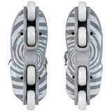 A pair of inline skates shown from the bottom, featuring gray and white zebra-stripe patterned decks with white wheels and gray footbeds.