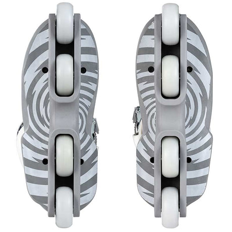 A pair of inline skates shown from the bottom, featuring gray and white zebra-stripe patterned decks with white wheels and gray footbeds.