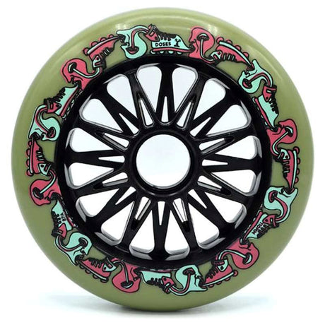 A single Inline skate wheel in green with black spokes and core. The wheel features a pink and light blue graphic with small text that reads "doses" "110mm" and "87a". The wheel is featured on a white background.