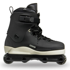 A black inline skate boot with a cream-colored midsole and black wheels, shown from a side profile on a white background.
