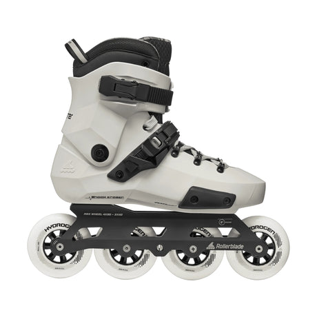 A white and black inline skate with four white wheels, shown from a side profile on a solid white background. The brand 'Rollerblade' is visible on the black frame.