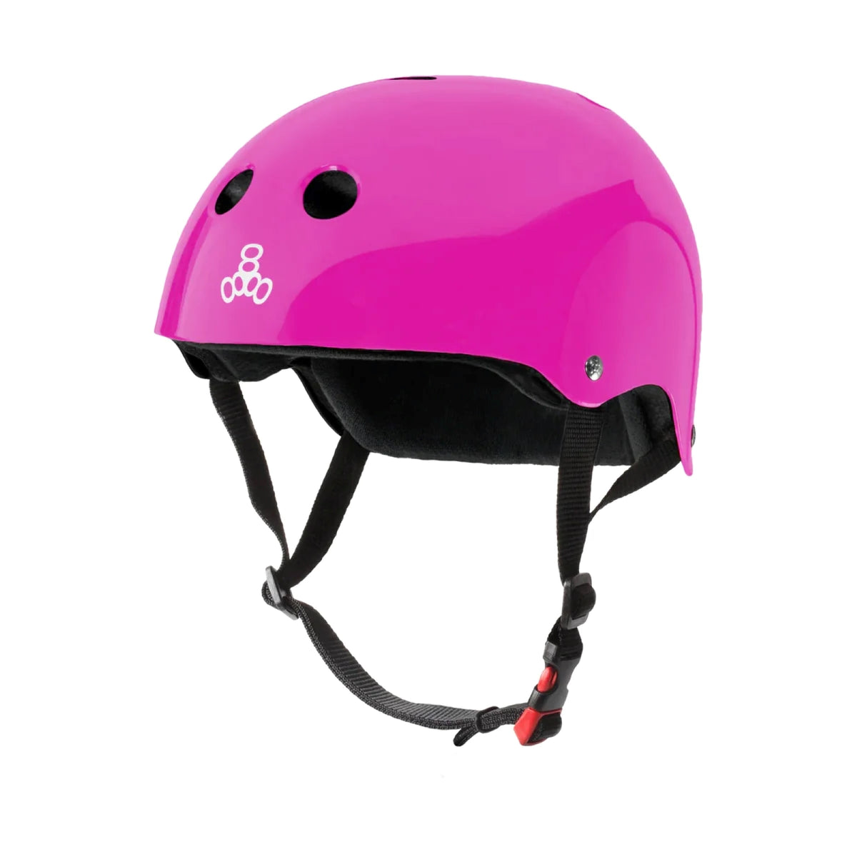 Glossy Pink helmet featuring two small holes in the front top, a white logo in the front near the rim, a silver rivet on the side, a black liner inside the helmet and a black strap with a red buckle hanging down. The pink helmet is positioned as if someone had it on the their head and the image is featured against a white background.